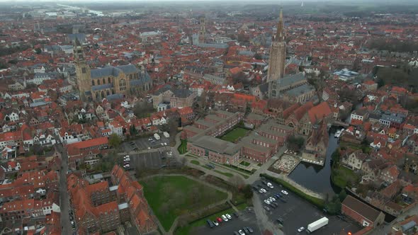 Aerial rotation of Bruges near churches and old hospital