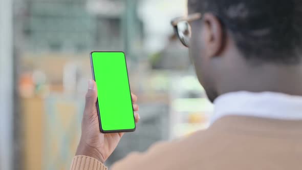 African Man Using Smartphone with Green Chroma Key Screen