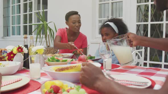 Happy family eating together at table