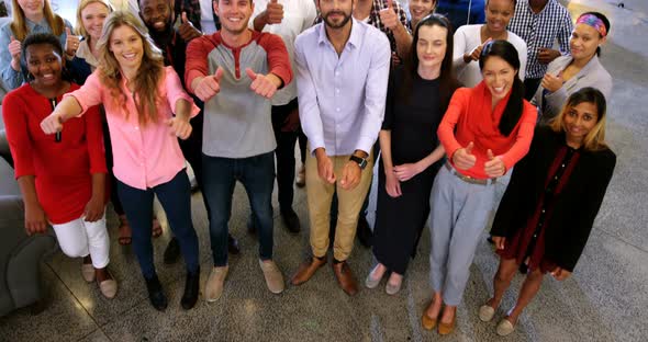 Portrait of business team gesturing together in office