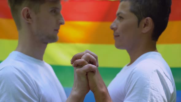 Homosexual Men Kissing on Rainbow Flag Background, Society Tolerance, Community