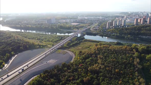 Video From a Drone View of the Road Bridge Over the River in the City