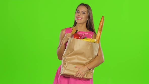 Girl Pressed the Card and Package To Himself and Smiles, Green Screen