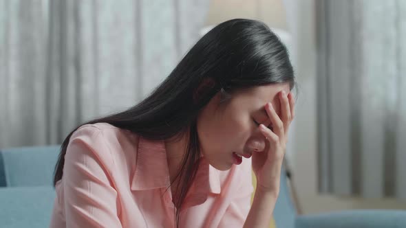 Close Up Of Asian Woman Having A Headache While Working With A Laptop At Home