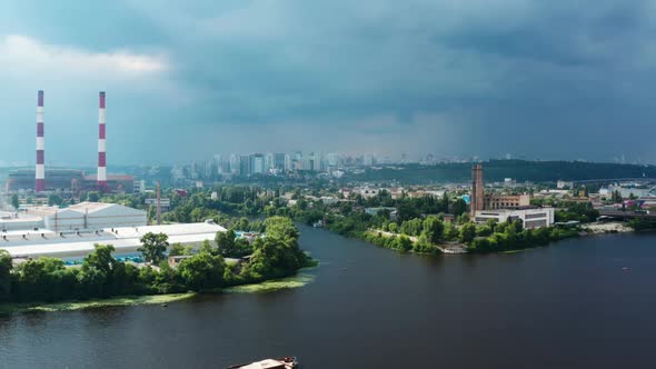 Aerial View of Industrial Factories and River Tugboat Towing Barge