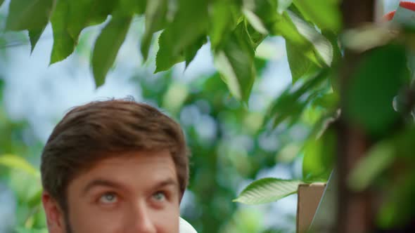 Happy Farmer Harvesting Cherry Tree on Farm Portrait