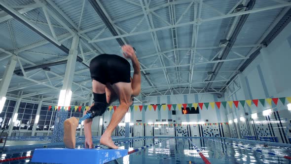 A Man with a Prosthesis Jumps Into a Pool, Artificial Leg