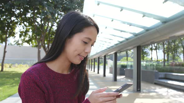 Woman use of mobile phone at outdoor 