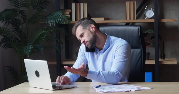 Businessman Using Laptop and Calling Smartphone in Same Time Working Overtime in Business Startup