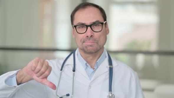 Middle Aged Doctor Showing Thumbs Down Sign