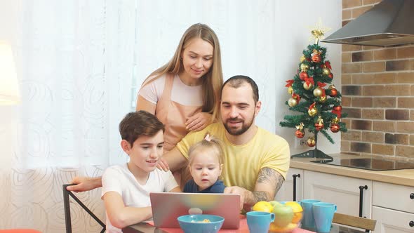 Caucasian Family Watching Film or Video While Having Breakfast