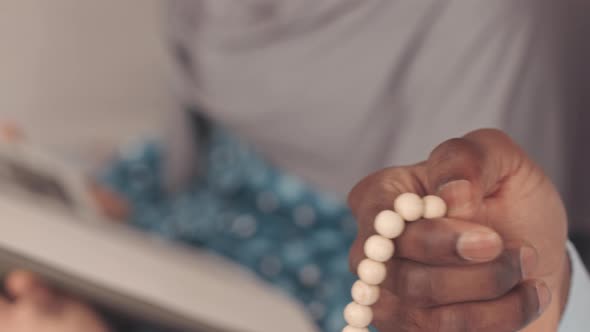 African American Muslim Man Holding Prayer Beads