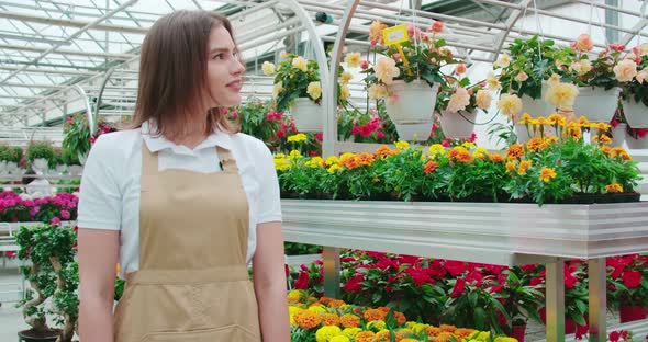 Smiling Woman Enjoying Incredible Smell and View Flowers