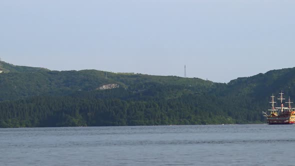 The view of traditional japanese ship enters right to the picture in Ashi lake