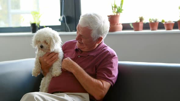 Senior man pampering dog