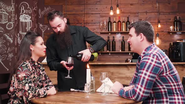 Waiter Pouring Wine From a Bottle