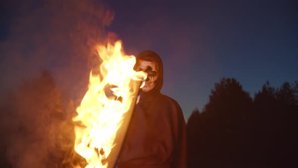 Grim Reaper with Burning Scythe Terrifying in Dark
