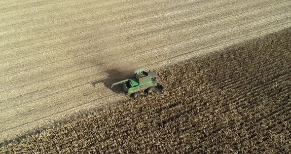 Aerial View of a Harvester Harvesting Corn in the Field