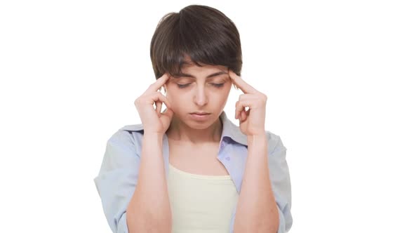 Concentrated Caucasian Female with Shirt Dark Hair Holding Temples Suffering From Terrible Headache