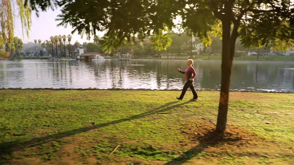 Senior Woman Working Out In The Park