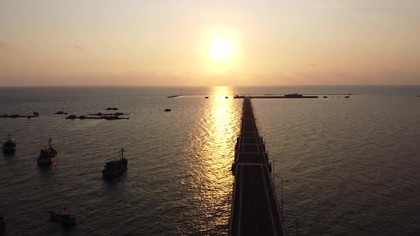 Aerial View of the Pier on the Ocean At Sunset View of the Sun and the Ocean In the Evening