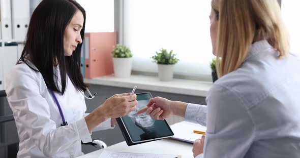Doctor Otorhinolaryngologist Showing Woman Patient Digital Tablet with Xray of Sinuses Movie Slow