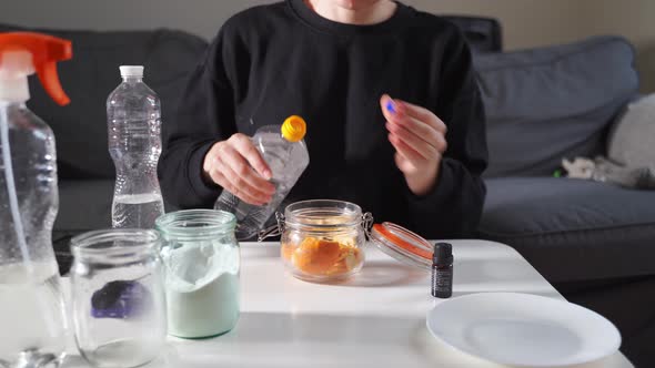 Millennial Girl Doing Diy Cleaning Spray at Home with Vinegar Soda and Lemon