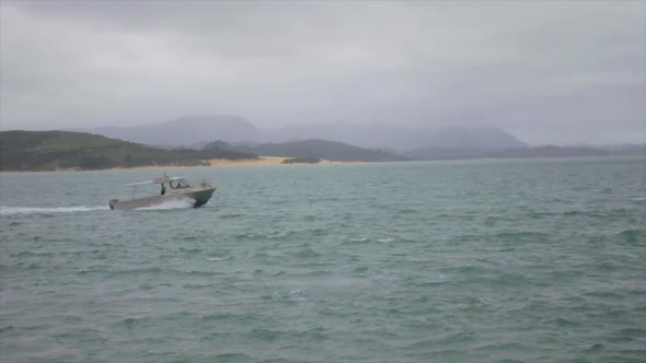 Wide shot in slow motion of a boat going toward a dock on a lake.