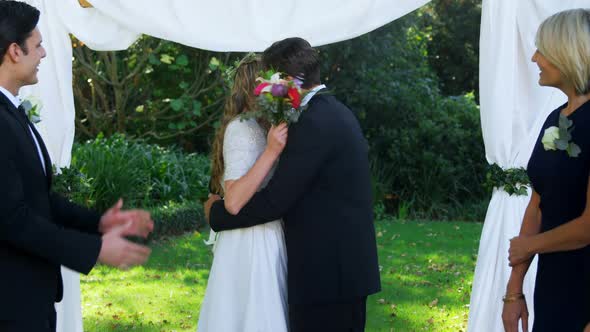 Happy smiling bride and groom hugging each other and people are clapping 4K 4k