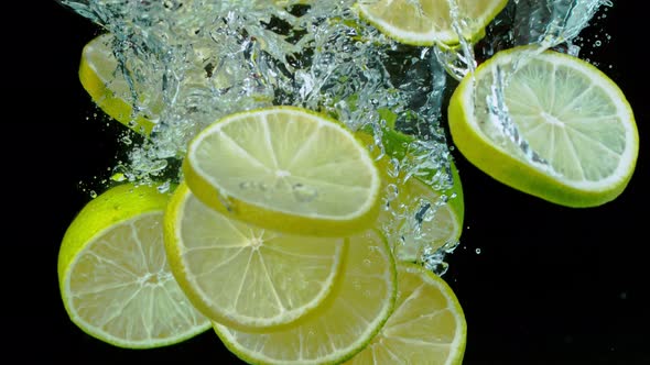 Super Slow Motion Shot of Falling Limes Into Water at 1000Fps
