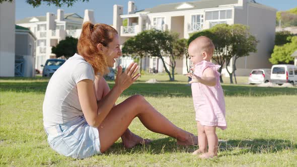 Happy Moms and Baby on a Walk in the Park