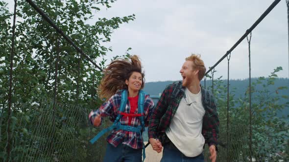 Two Backpackers Racing Nature on Mountain Countryside