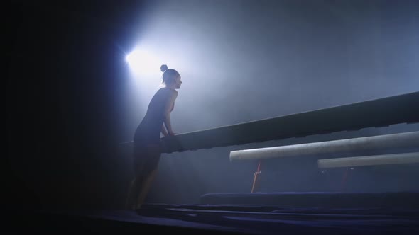 Young Female Athlete is Performing Exercise on Balance Beam Training Alone at Night Slow Motion Shot