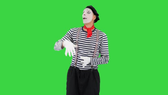 Mime Artist Holding Imaginary Balloons and Flying on a Green Screen Chroma Key