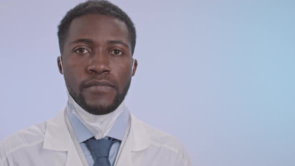 Portrait of African-American Doctor Taking Off Face Mask