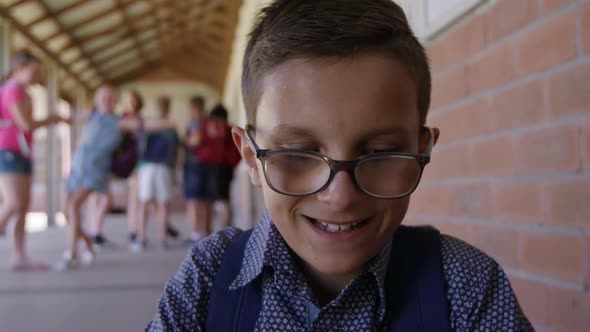 Boy with glasses in the school corridor