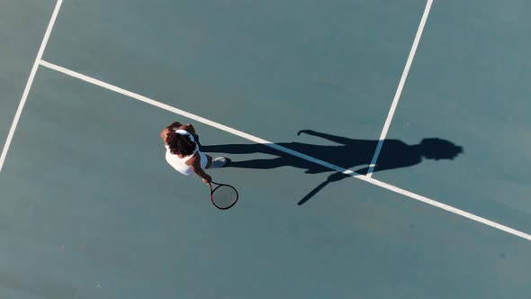 Video of top view of biracial female tennis player on court