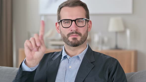 Portrait of Young Businessman Shaking Finger As No Sign 