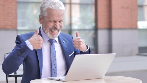 Old Businessman Celebrating Success on Laptop Outdoor