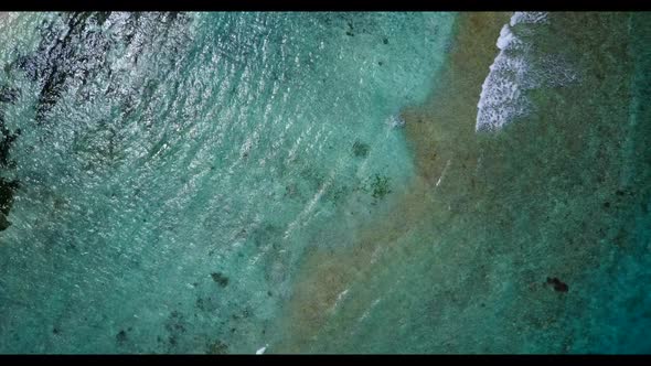 Aerial above nature of tranquil coastline beach break by turquoise water with white sand background 