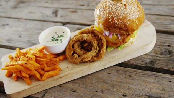 Snacks arranged on chopping board