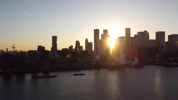 Aerial - Sunset over River Thames and Canary Wharf, London, scenic pan right