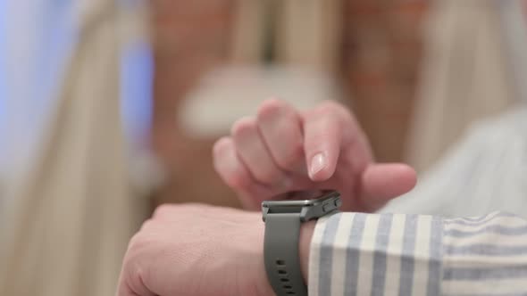 Portrait of Middle Aged Man using Smart Watch