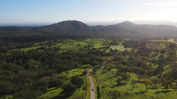 Drone shot following a car through insane Costa Rican green landscape