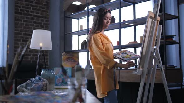 Inspired Female Artist Creating Painting on Canvas