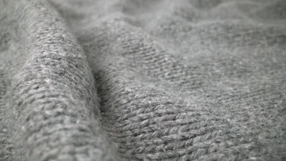 Extreme detail view of sheep wool cloth texture flowing in macro dolly shot.