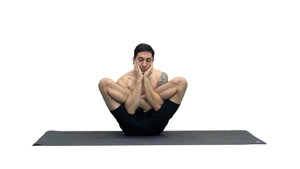 Muscular handsome young man working out yoga, lotus, hands