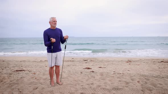 Mature Man Exercising At The  Beach