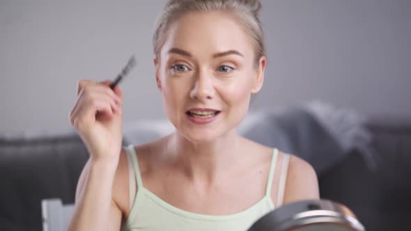 Portrait of Female Beauty Blogger Woman Shows How to Apply Makeup on Face Makes a Stream on Social