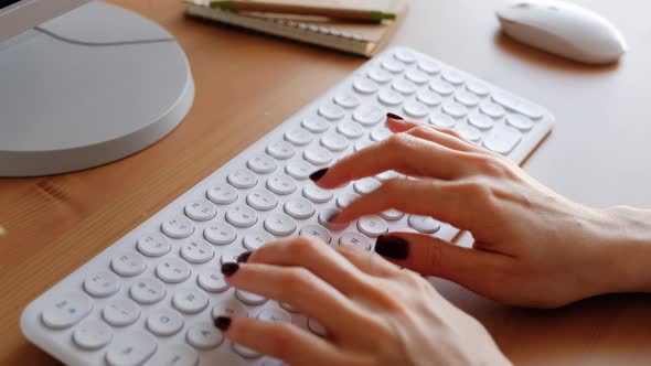 Woman typing on computer keyboard. Closeup 4k footage